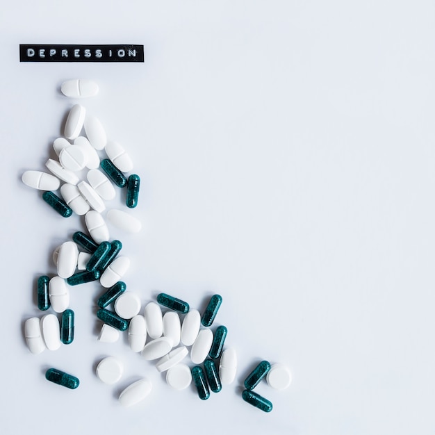Capsules and tables with depression label on white background
