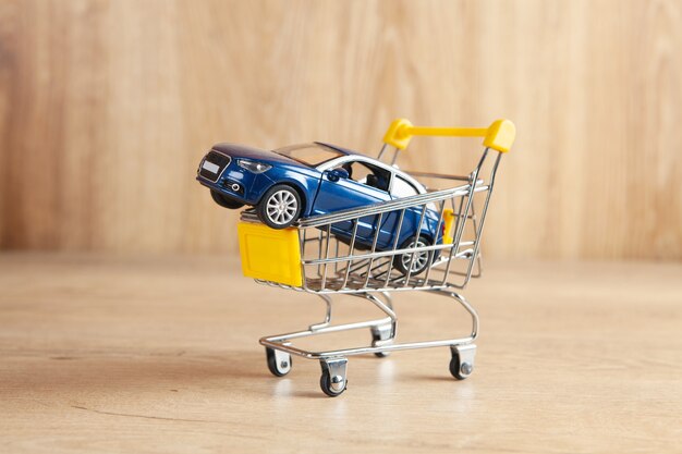 Car in a basket on a wooden background