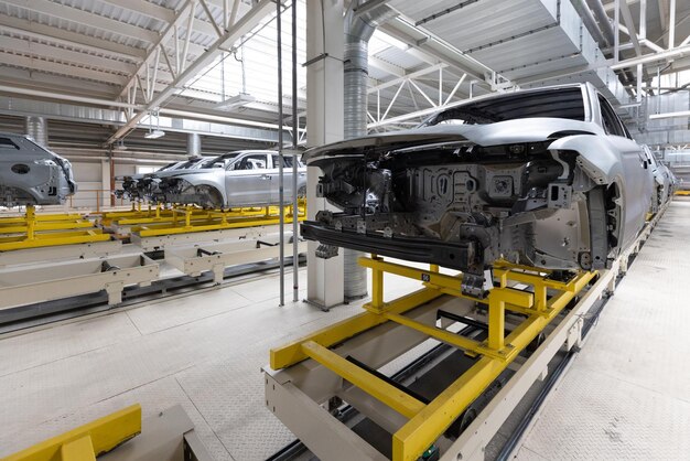 Car bodies are on assembly line Factory for production of cars Modern automotive industry
