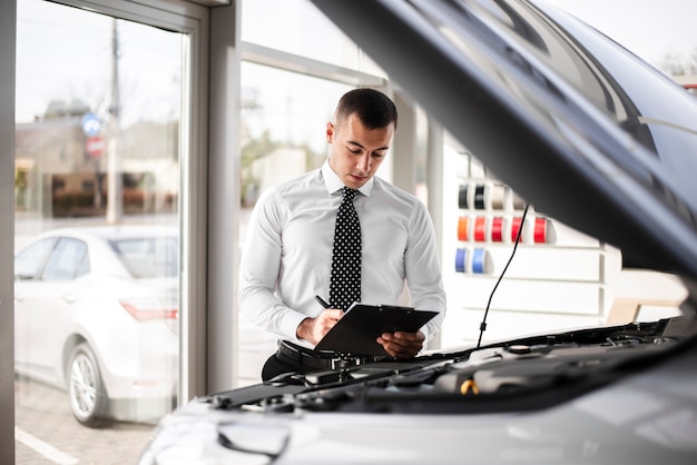 Car dealer signing papers