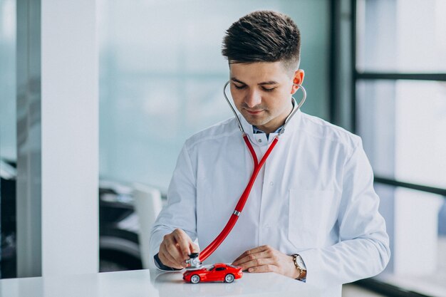 Car doctor with stethoscope in a car showroom