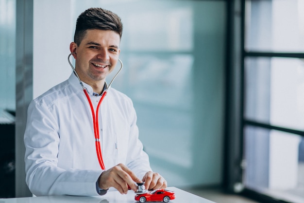 Car doctor with stethoscope in a car showroom