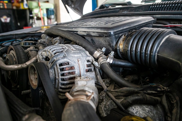 Car engine alternator detail in a mechanical workshop