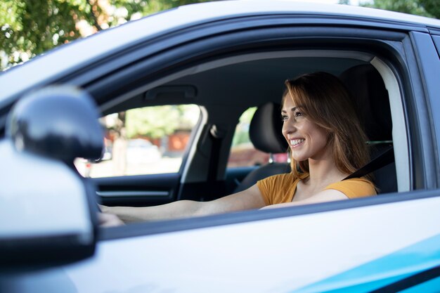 Car interior view of female driver enjoys driving a car