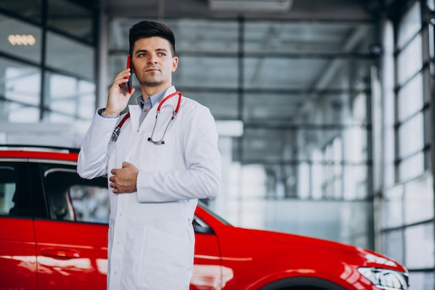 car technician with stethoscope in a car showroom talking on the phone