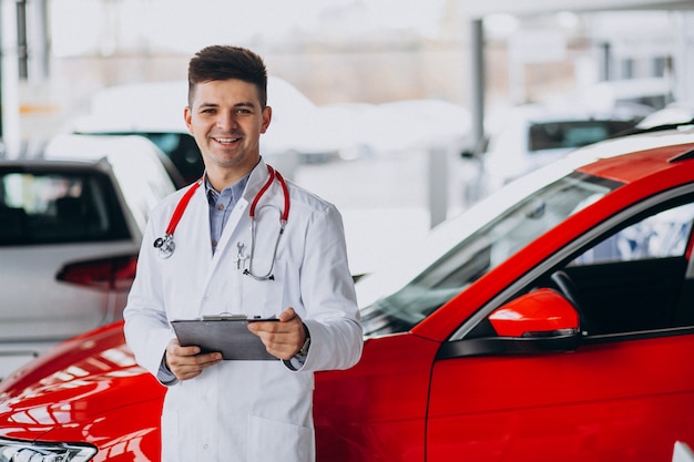 car technician with stethoscope in a car showroom