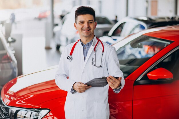 car technician with stethoscope in a car showroom