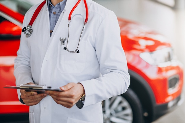 car technician with stethoscope in a car showroom