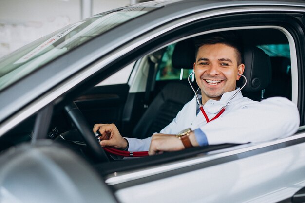 car technician with stethoscope in a car showroom