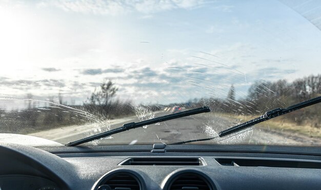 Car wipers clean windshields when driving in sunny weather