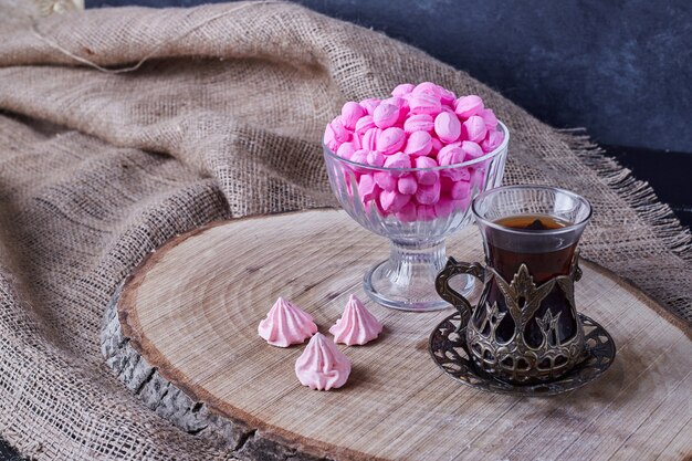 Caramel candies with a glass of tea. 