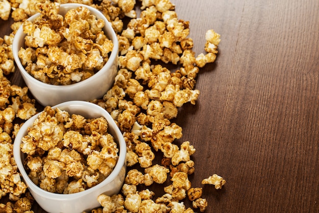 Caramel popcorns on white bowls