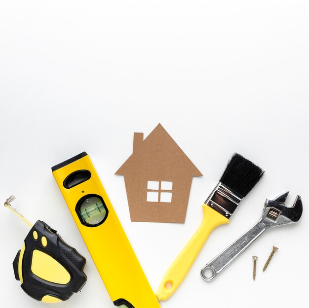 Cardboard house and repair tools with copy space
