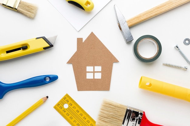 Cardboard house surrounded by repair tools