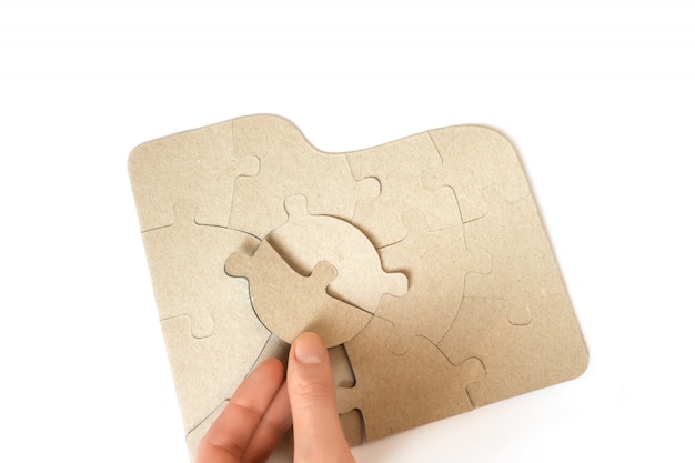 Cardboard puzzles in female hands, close up.