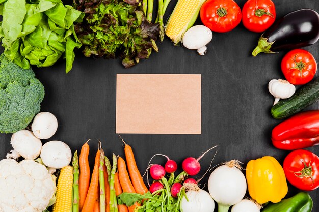 Cardboard with vegetables around