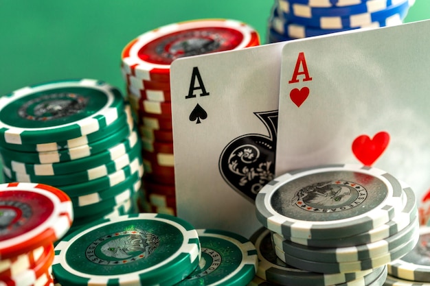 Cards and chips for poker on green table