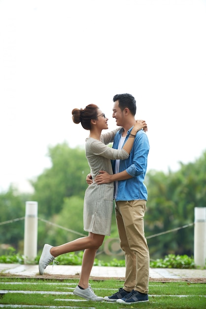Free photo carefree asian couple embracing on date