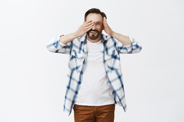 Carefree bearded mature man posing