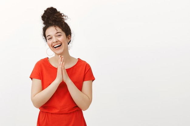 Carefree beautiful female sibling in trendy red dress