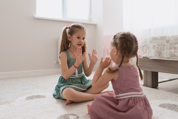 Carefree cute girls playing lovely at home