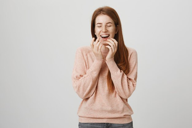 Carefree cute redhead girl laughing