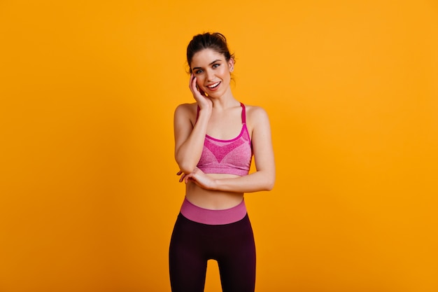 Carefree fitness woman posing with smile
