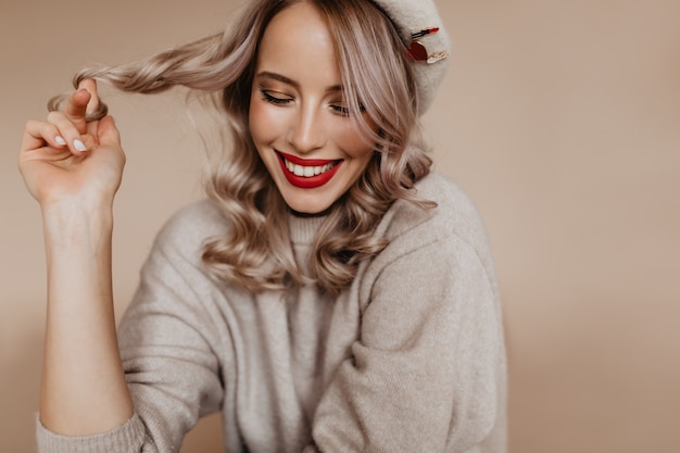 Free photo carefree french woman in brown sweater enjoying photoshoot