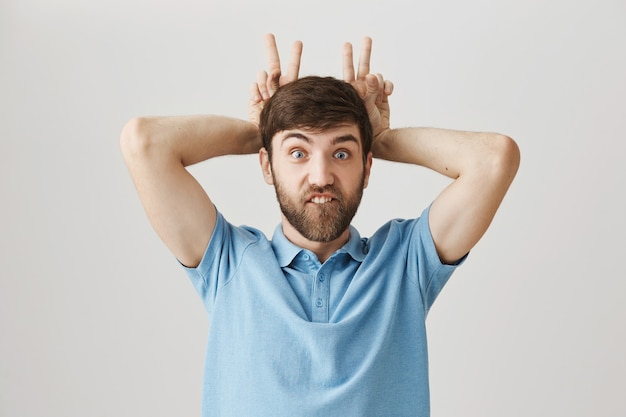 Carefree funny young bearded man posing