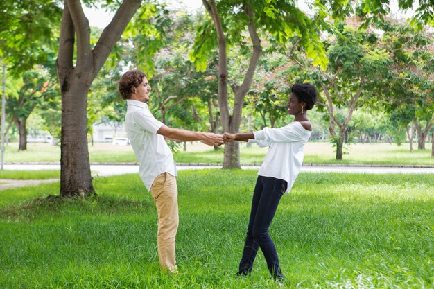 Carefree happy couple holding hands and spinning