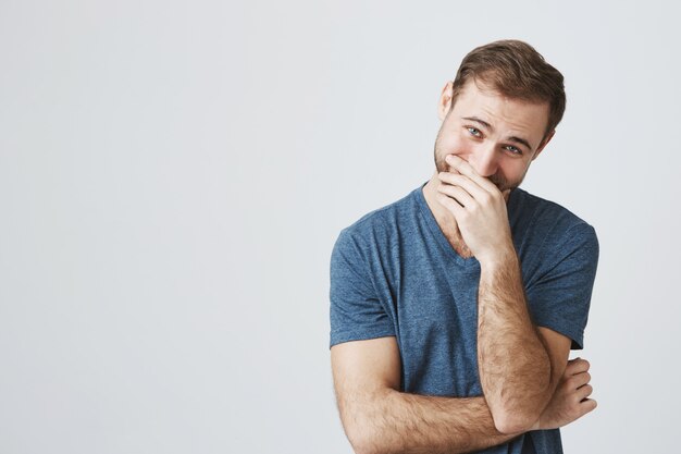 Carefree happy guy laughing over joke