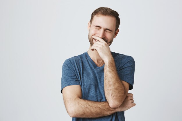 Carefree happy guy laughing over joke