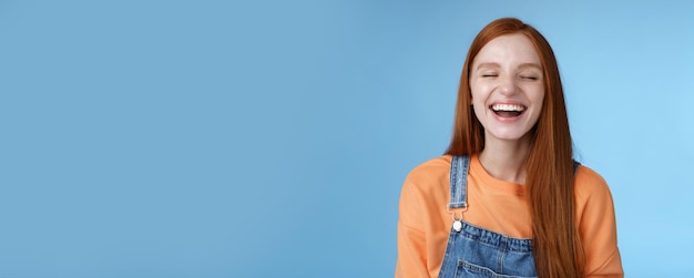 Carefree happy positive lucky redhead girl having fun close eyes smiling optimistic laughing out