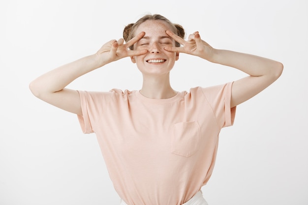 Free photo carefree happy teenage girl posing against the white wall