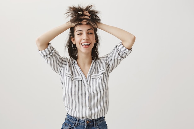 Carefree happy woman tossing hair and smiling