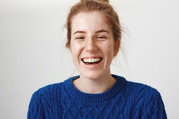 Carefree laughing redhead girl with beautiful smile