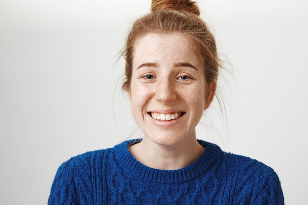 Carefree laughing redhead girl with beautiful smile