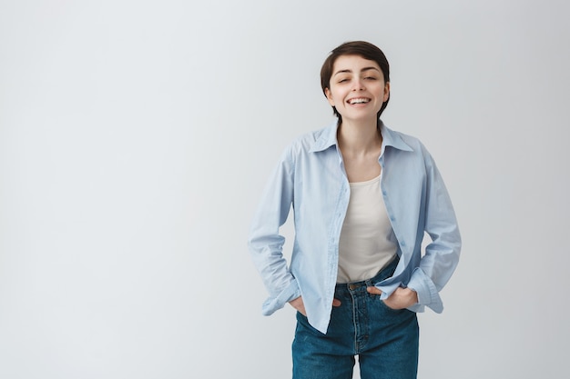 Carefree queer girl laughing and looking joyful