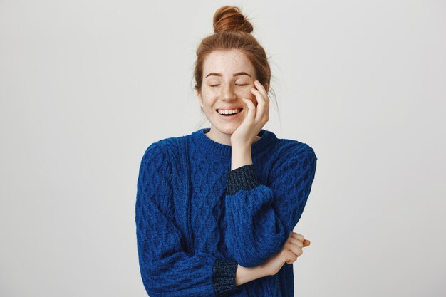 Carefree smiling and cheerful redhead woman laughing