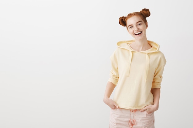 Carefree smiling redhead girl with silly haircut