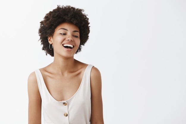 Carefree stylish girl posing against the white wall