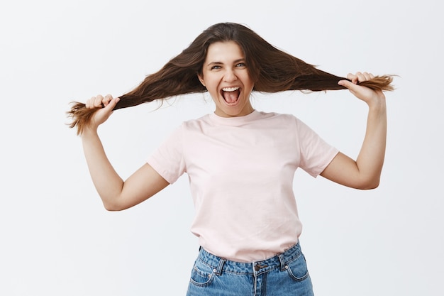 Carefree and wild young brunette posing