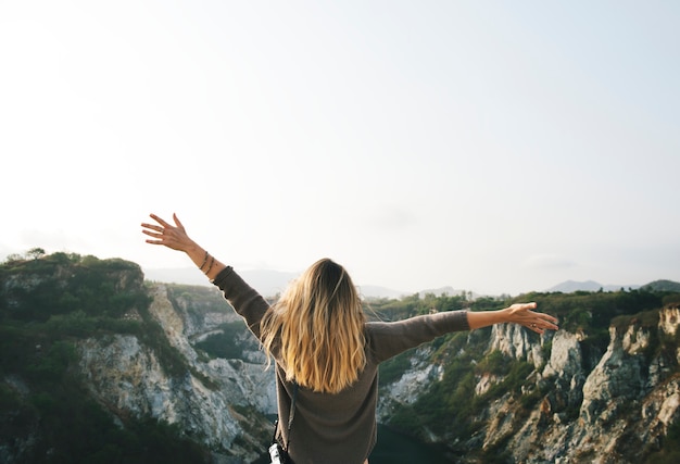 Carefree woman arms outstretched on the mountain