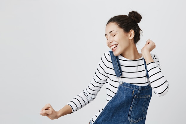 Carefree woman dancing with closed eyes