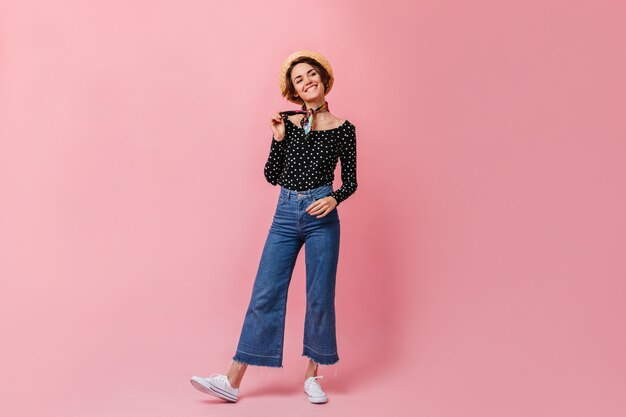 Carefree woman in vintage jeans looking at front