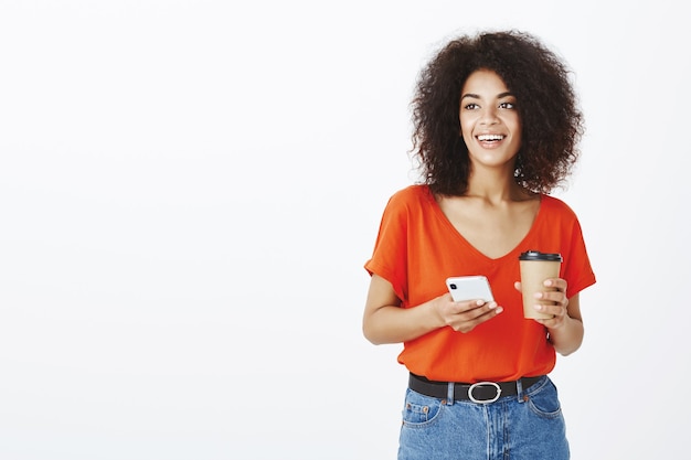 Free photo carefree woman with afro hairstyle posing in the studio