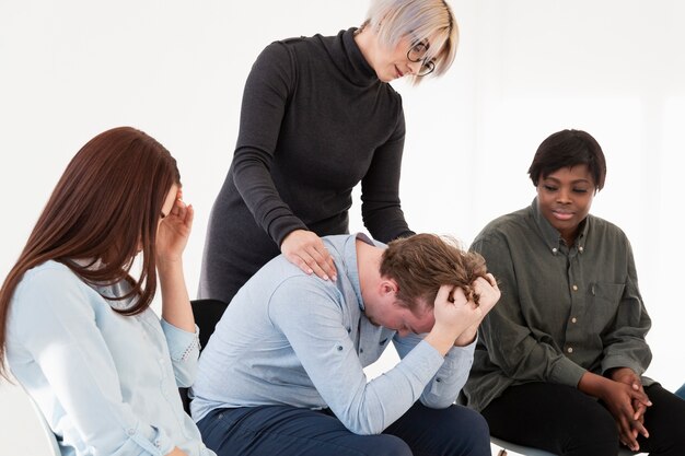 Careful doctor consoling rehab patient