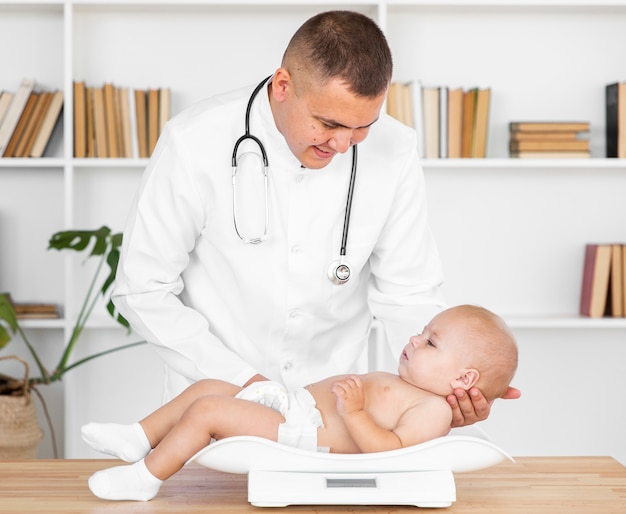 Careful doctor holding baby patient head