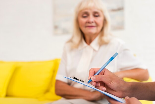 Caregiver writing on clipboard close-up