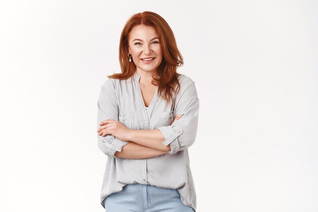 Caring lovely happy middle-aged redhead woman cross arms chest smiling joyfully talking lively discuss child grades school teacher grinning laughing have interesting conversation, white wall